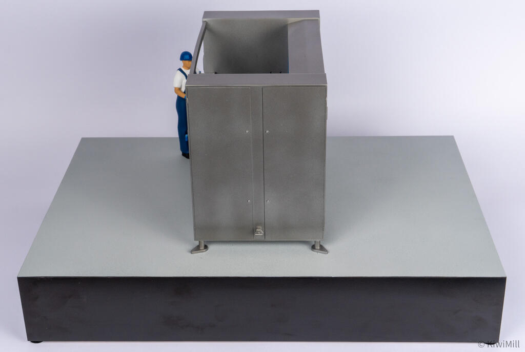 Raised end view of the belt chiller model looking into the open top above the double access doors and leveling feet